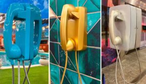 Big Fone do BBB 26 em três cores — azul, dourado e prateado — espalhados pela casa do Big Brother Brasil, usados na dinâmica que define quem atende o telefone ao vivo.